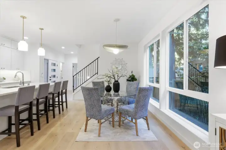 Formal dining room between the kitchen and wall of windows. Formal dining room between the kitchen and wall of windows.