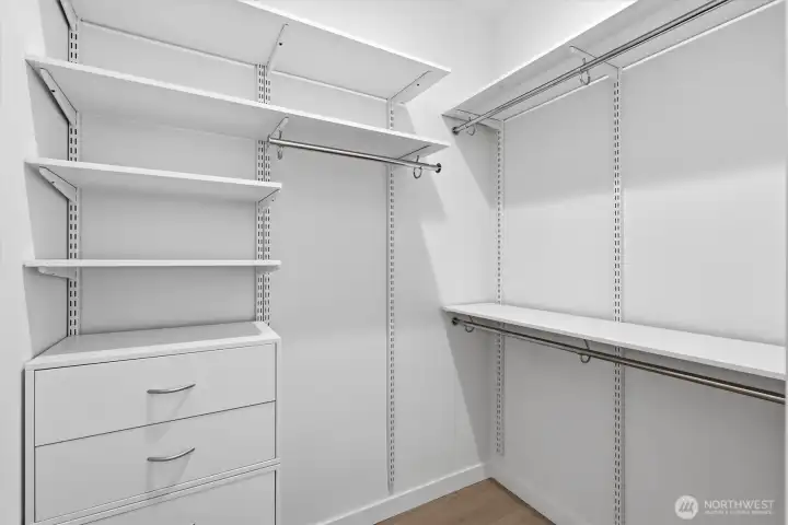 Primary's walk-in closet with built-ins. Primary's walk-in closet with built-ins.