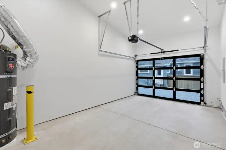 Large garage for new construction. Door is 9' wide instead of the usual 8' and there's still room for storage alongside the door. High ceilings give option of additional hanging storage racks. Large garage for new construction. Door is 9' wide instead of the usual 8' and there's still room for storage alongside the door. High ceilings give option of additional hanging storage racks.