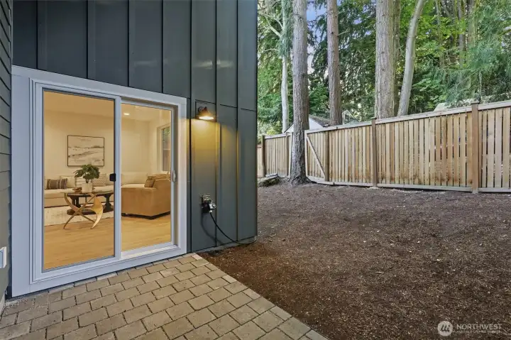 Paver patio with sliding door leading to the living room/kitchen. Paver patio with sliding door leading to the living room/kitchen.