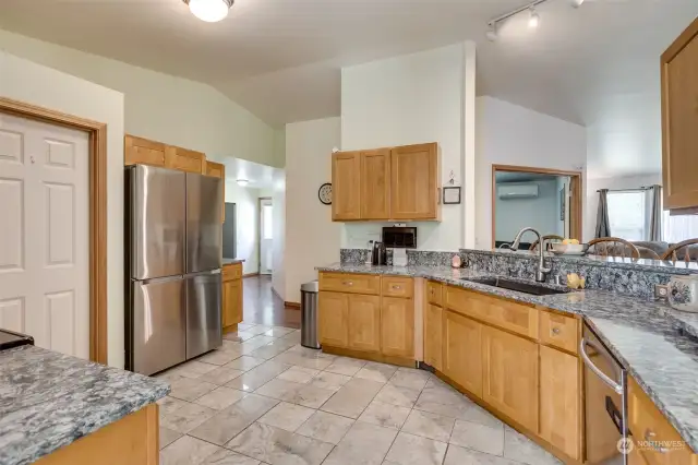 Kitchen is open with granite countertops, open sight lines to living room, large walk in pantry & stainless steel appliances.