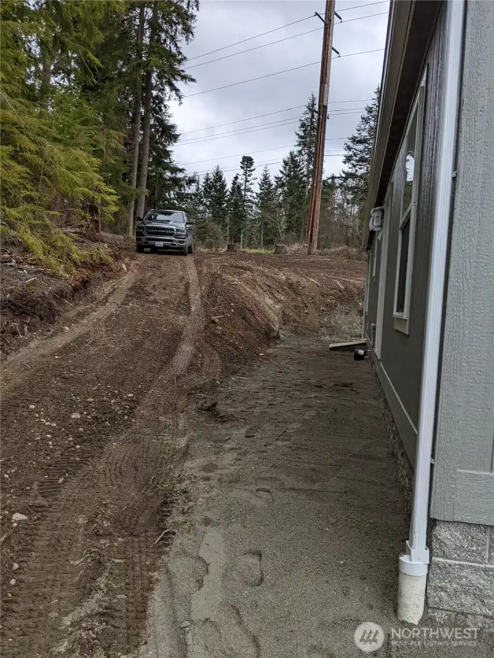 Extra driveway was graded for access to upper level.
