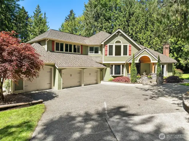 Beautiful NW Architecture accentented with brick and rock. Spacious three bay garage with carriage style doors