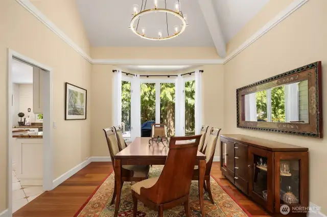 This home's formal dining room offers views of the large woodsy backyard.