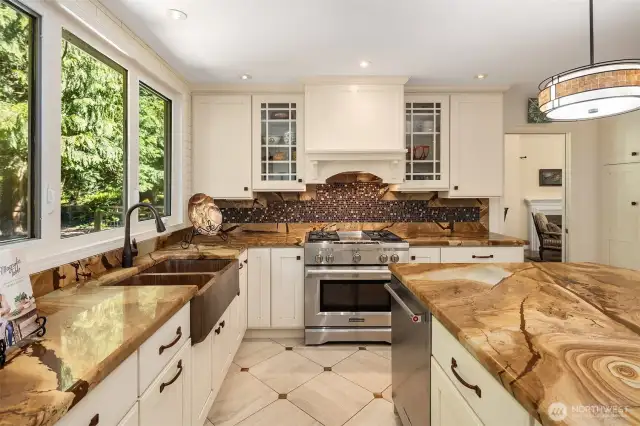 A chef’s dream, featuring premium appliances, bold stone surfaces, and a seamless indoor-outdoor connection.