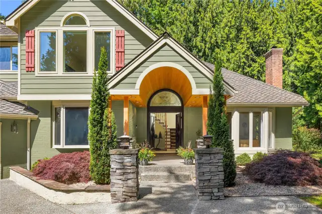 This home is a beauty that stands out from the crowd thanks to its expressive entryway. The brick and stack stone exterior really highlight the unique architecture and fine craftmanship.