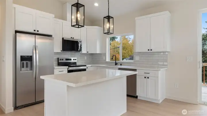 Stainless appliances including the fridge.