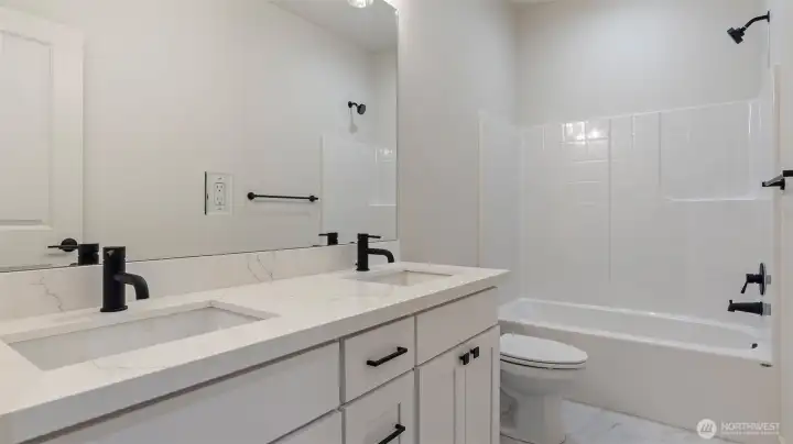 Main Bath has big vanity quartz counters, dual undermount sinks & tile flooring.