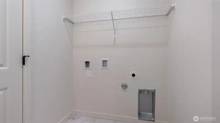 Laundry room has tile flooring.