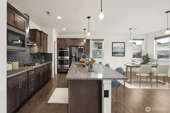 Fabulous kitchen/ dining open to the great room- Virtually staged