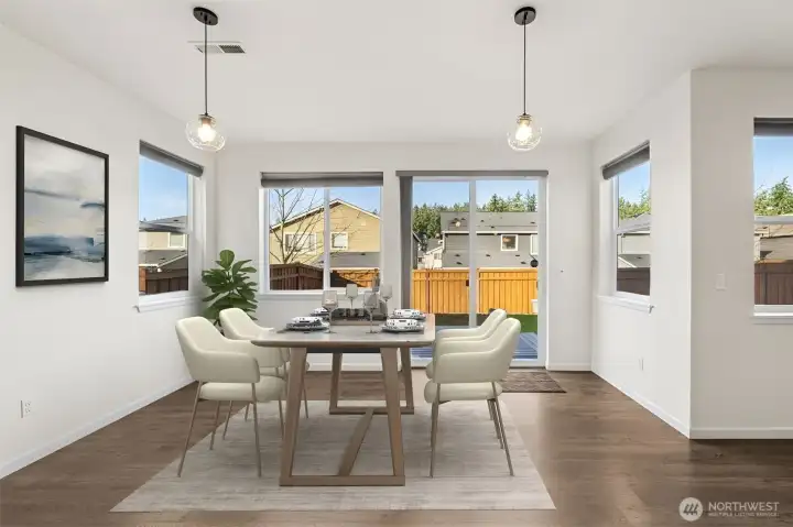 Tons of natural light in this open dining area. Virtually staged