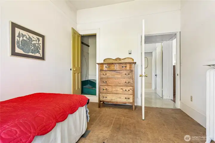 This bedroom has a staircase access to the unfinished attic space