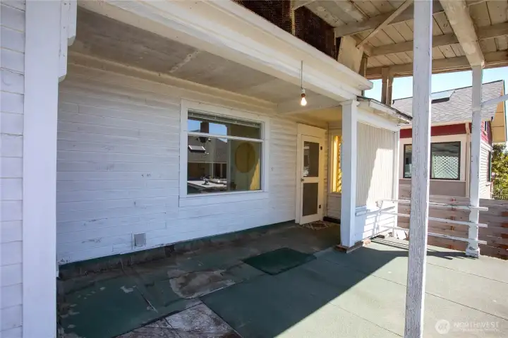 This door is from the enclosed porch leading to the front deck. The window here is from the kitchen area.