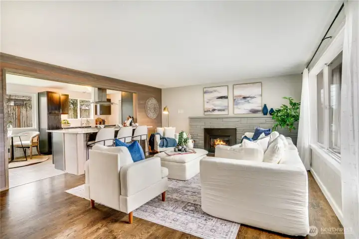 Warm Oak Hardwood floors, central gas fireplace and open kitchen/living space.