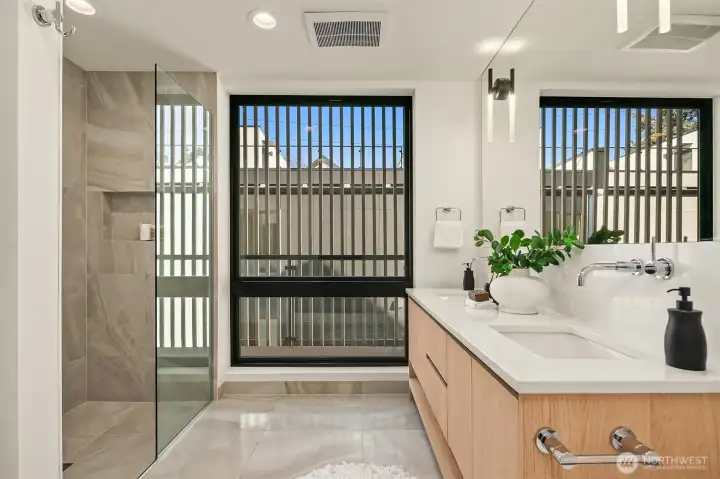 Primary bathroom with curbless shower and floating double vanity