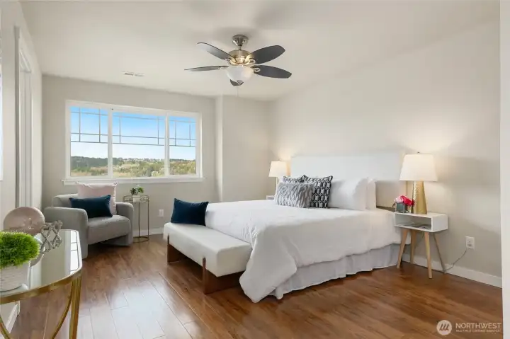 Spacious primary bedroom with nice view