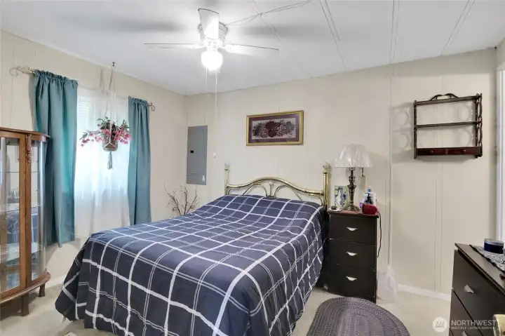 Primary bedroom with ceiling fan keeps you cool in summer.