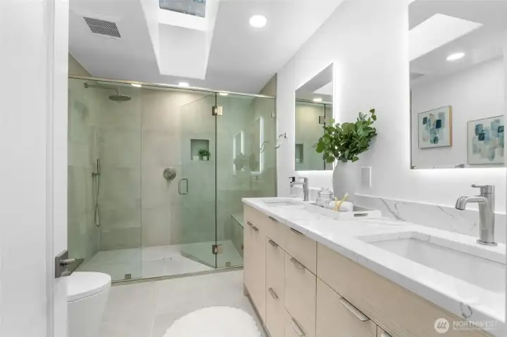 New primary bath with new cabinets, dual sinks, quartz counters and large curb-less designer shower.