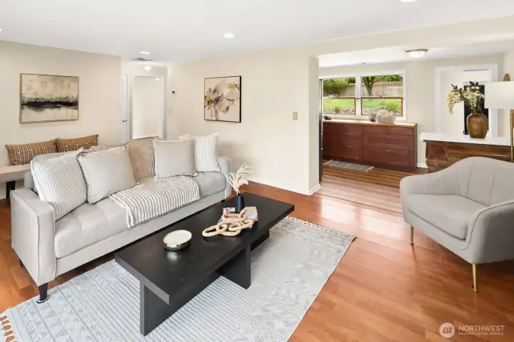 The living room opens into the kitchen where additional windows let light in from both sides of the house.