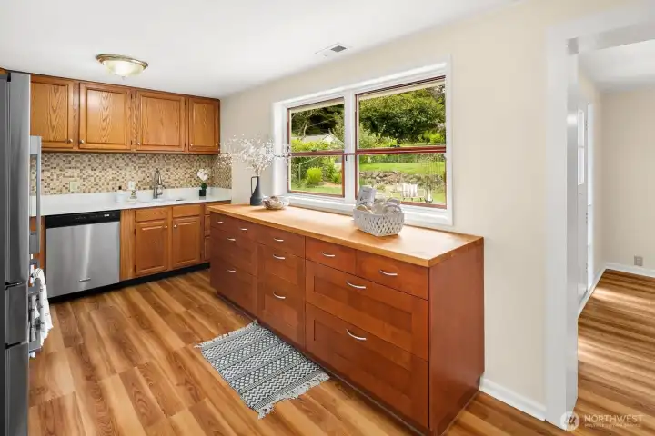 The kitchen overlooks the backyard patio.  The dutch door around the corner opens right outside - perfect for summer BBQ's!