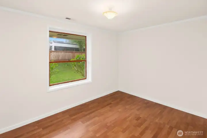 Bedroom 3 offers views of the lawn and garden in the front yard.