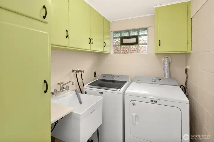 Easy to use laundry room offers full size washer and dryer, laundry sink, and additional storage.