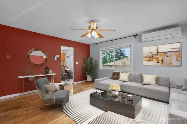 Virtually staged living room showcasing the home’s bright and inviting layout, hardwood floors, abundant natural light and efficient mini-split heating and cooling system.