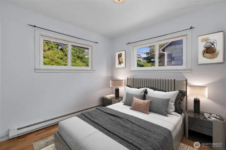Virtually staged bedroom featuring hardwood floors, abundant natural light and a comfortable layout designed for relaxation.