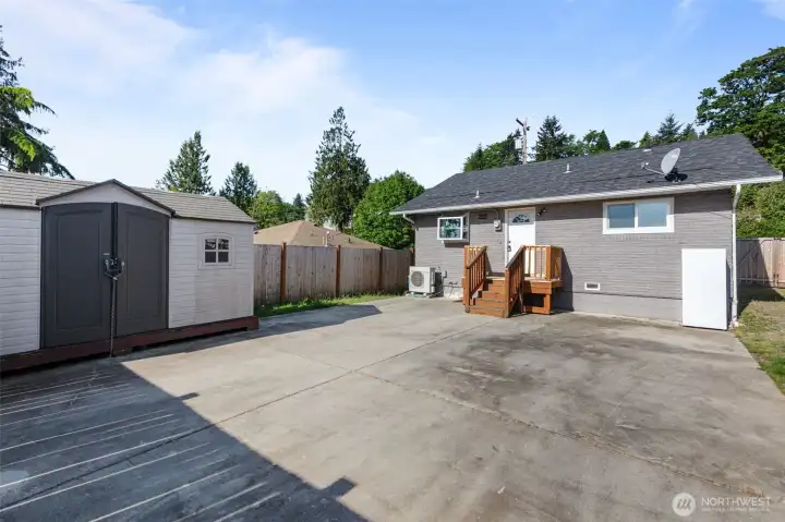 Spacious backyard featuring an oversized paved entertaining area, storage shed and fully fenced setting with endless possibilities for outdoor living.