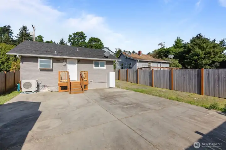 Large fully fenced backyard with expansive paved area, private rear access and plenty of space for entertaining, recreation or additional parking.