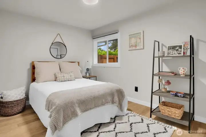 And the second bedroom is staged with a double bed and includes a 6' closet.