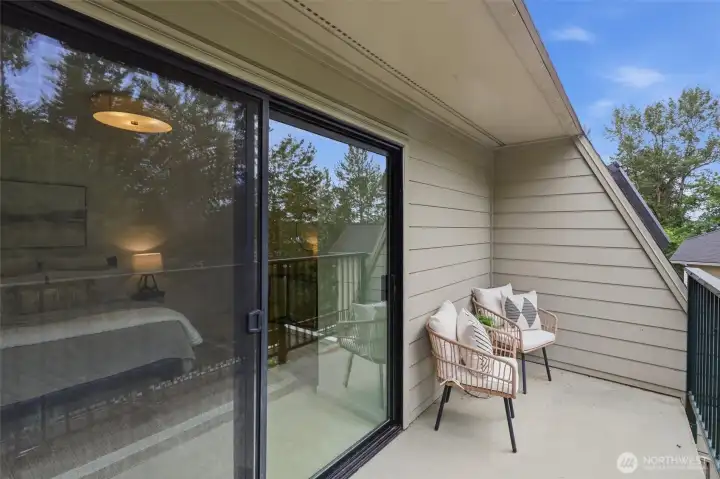 Deck/patio off primary bedroom overlooks the large main deck and seasonal city views.