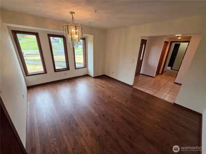 Dining room with kitchen to the left and entry to right. Hallway leads to the bedrooms Dining room with kitchen to the left and entry to right. Hallway leads to the bedrooms