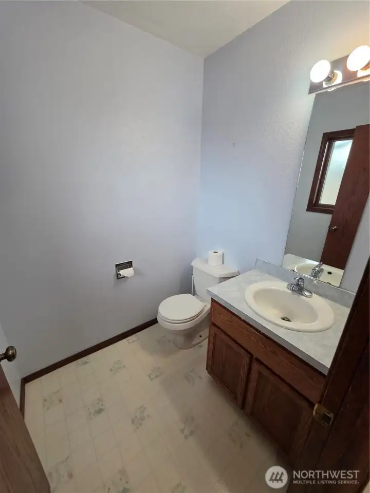 1/2 bath off utility room with door to the deck. 1/2 bath off utility room with door to the deck.