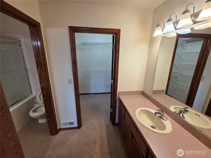 Primary bathroom and entry to walk in closet. Primary bathroom and entry to walk in closet.
