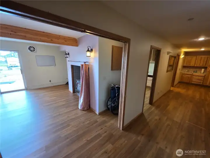 Lower living space with wood stove. Hallway to bath and bedroom. Lower living space with wood stove. Hallway to bath and bedroom.