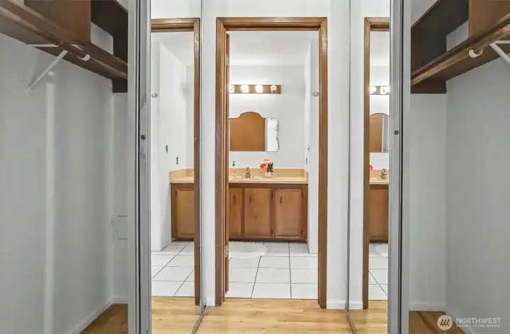 Large primary closets looking into the secluded bathroom.