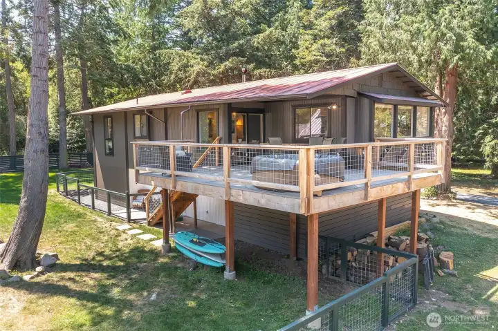 New low-maintenance deck off the dining area offers a lovely place to take in the water views and overlook the spacious yard, with enclosed under-deck storage below.