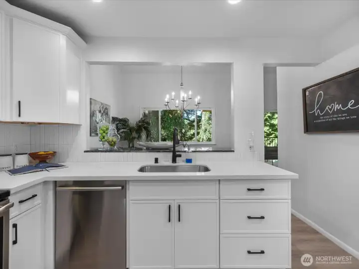 View out to the dining room and greenery from the kitchen. View out to the dining room and greenery from the kitchen.