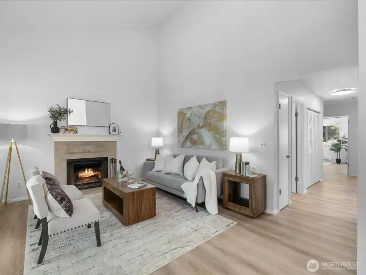 Living room is bright with vaulted ceilings and a natural wood burning fireplace. Living room is bright with vaulted ceilings and a natural wood burning fireplace.