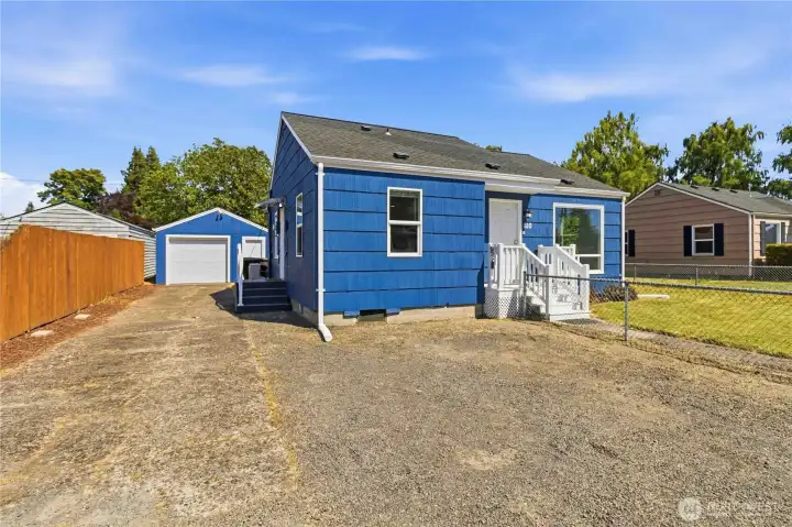 Long Driveway with Detached Garage and Side Entrance into Home