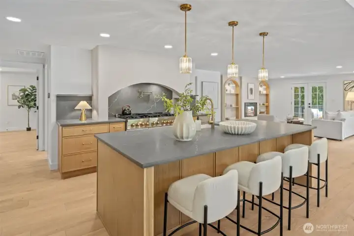 This property affords a sweeping view from the kitchen through to the great room, where an arched built-in and electric fireplace continue the home's signature architectural details. Wide-plank engineered hardwood runs throughout, unifying the spaces for easy everyday living and entertaining. This property affords a sweeping view from the kitchen through to the great room, where an arched built-in and electric fireplace continue the home's signature architectural details. Wide-plank engineered hardwood runs throughout, unifying the spaces for easy everyday living and entertaining.