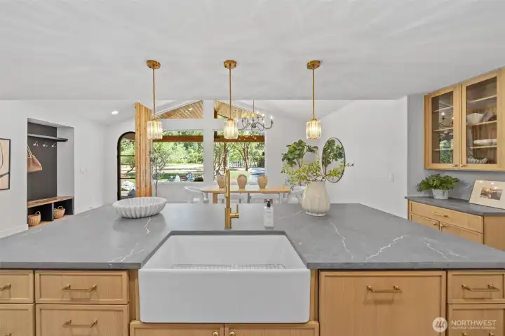 This home invites easy conversation, with island seating positioned to keep the cook company while overlooking the dining space and wooded views beyond. The open sightline makes it effortless to host, entertain, and stay connected to the gathering happening just steps away. This home invites easy conversation, with island seating positioned to keep the cook company while overlooking the dining space and wooded views beyond. The open sightline makes it effortless to host, entertain, and stay connected to the gathering happening just steps away.