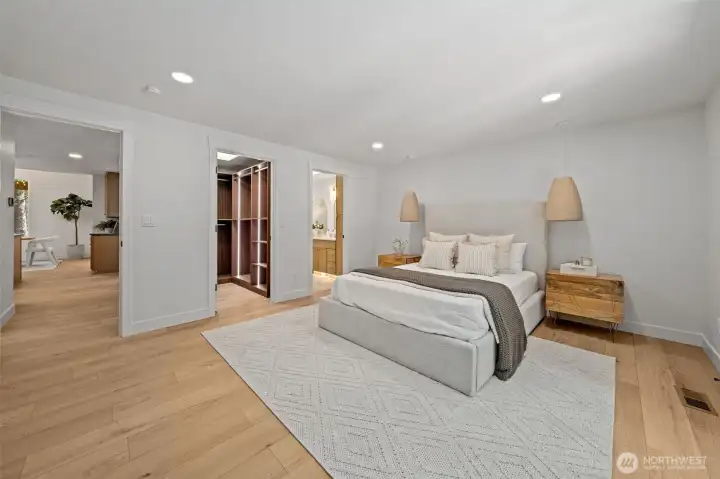 The Primary Suite features a spacious walk-in closet with custom built-in lighting and shelving, just steps from the ensuite bath. Door offer privacy while maintaining an open, flowing connection to the rest of the home. The Primary Suite features a spacious walk-in closet with custom built-in lighting and shelving, just steps from the ensuite bath. Door offer privacy while maintaining an open, flowing connection to the rest of the home.