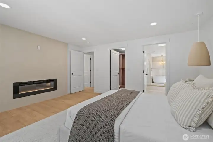 The Primary Suite features a sleek linear fireplace that anchors the feature wall, adding warmth and architectural interest. The Primary Suite features a sleek linear fireplace that anchors the feature wall, adding warmth and architectural interest.