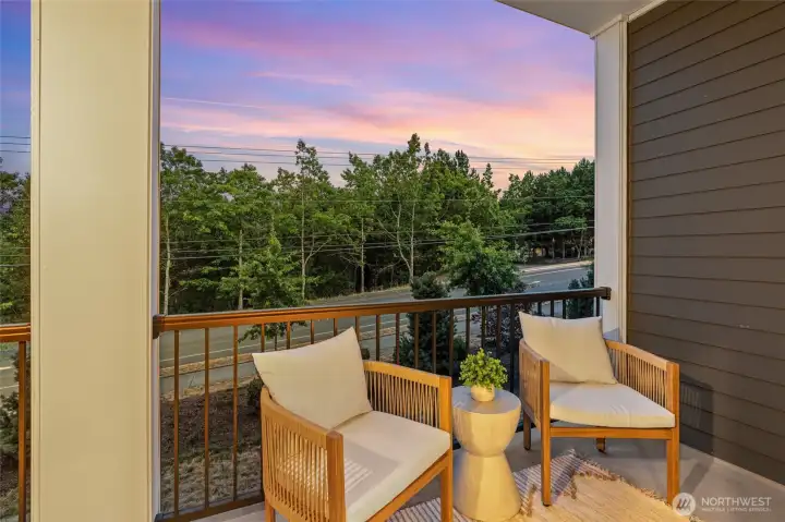 A covered balcony extends the living space outdoors for dining, entertaining, and unwinding.