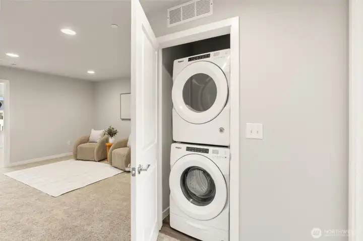 Stackable laundry with adjacent storage keeps daily routines running smoothly.