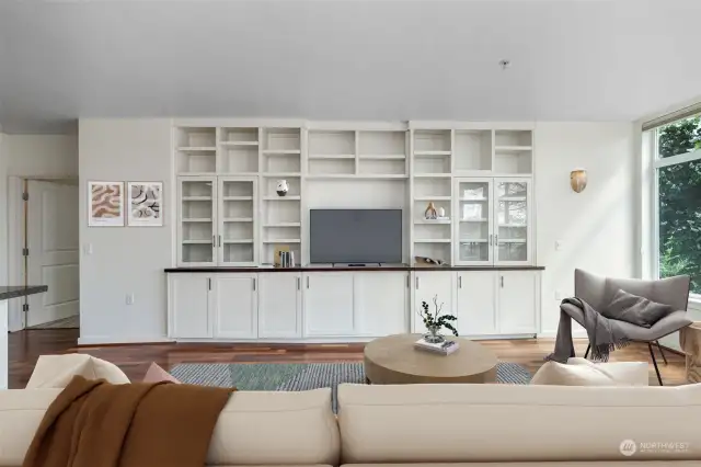 Custom built in book shelves with ample storage and space for entertainment systems. This condo is Virtual Staged.