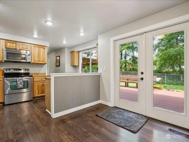 French doors out to the back deck. Casual eat in kitchen/dining space in front of the doors.