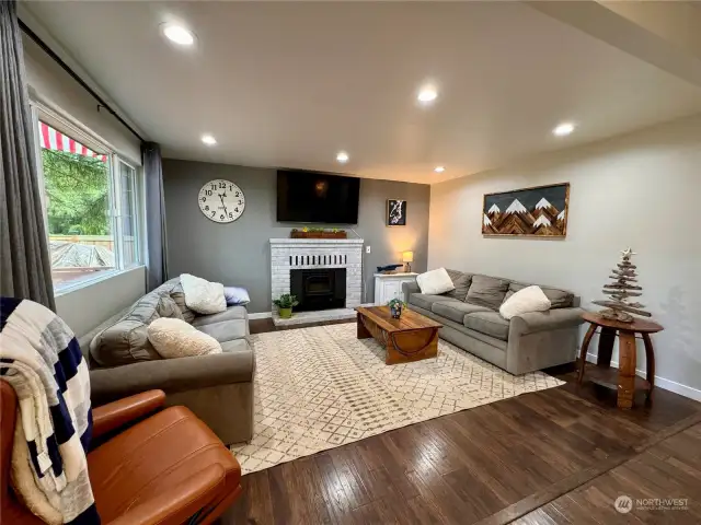 Large family room with wood burning fireplace insert.